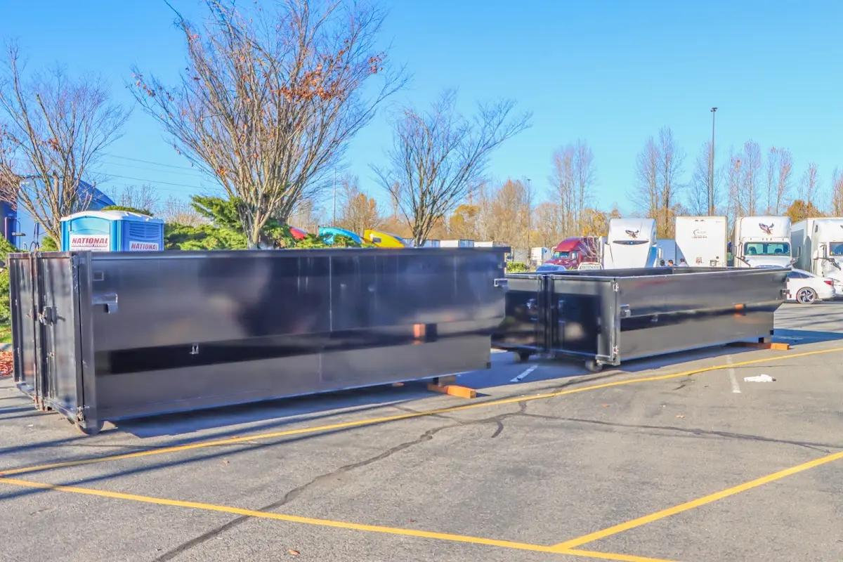 Professional dumpster rental service with roll-off container on residential driveway in West Ocean City